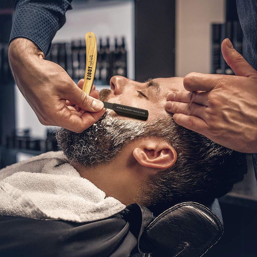 Rasage traditionnel au coupe-chou chez un barbier